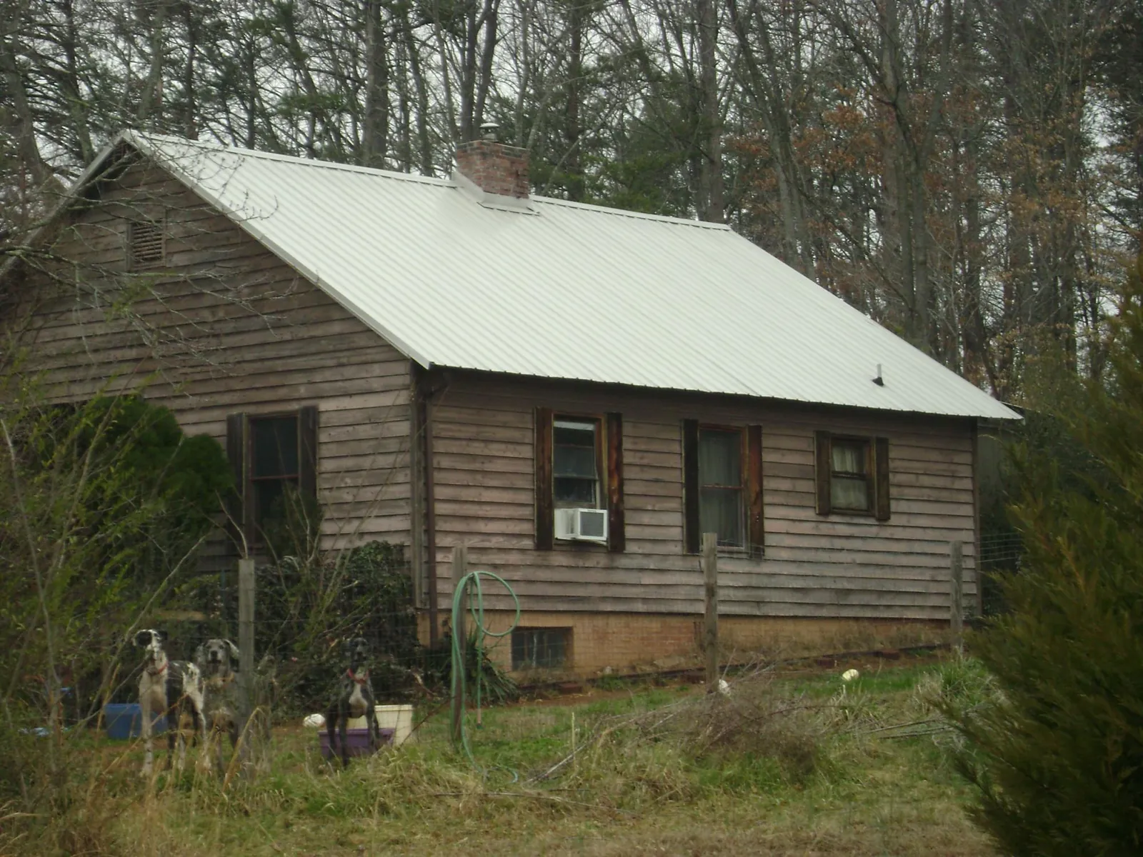 White metal roof on an old wood sided farmhouse, from a Metal Roof Installation job in Baldwin Place
